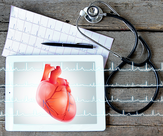 An image showing a heart displayed on a digital tablet with an ECG report printout and a stethoscope.