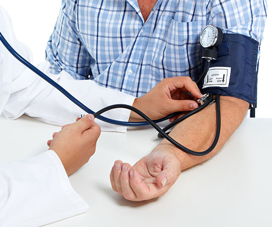 A medical professional monitors the blood pressure of a patient.