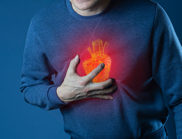 A man holding his chest because of sudden cardiac arrest.