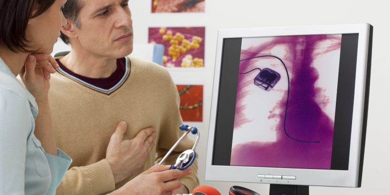 A image of a man having consultation with doctor about his pacemaker.