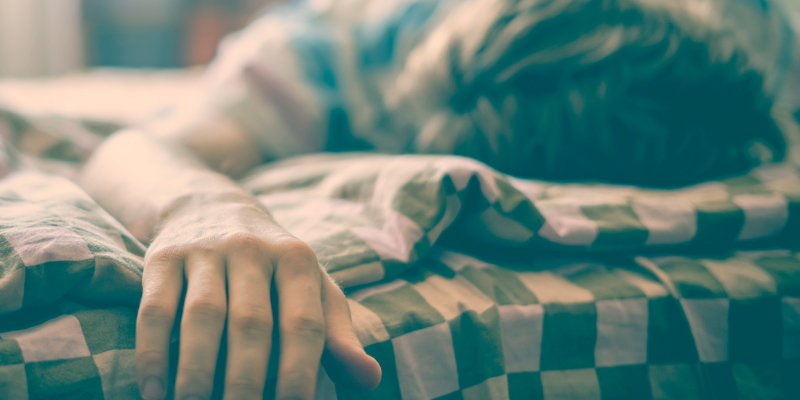Image of a young man sleeping in the daytime due to sleep apnea illustrates the relation between sleep apnea and cardiovascular disease.